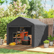 Dark grey shed on a decked patio with a workbench and storage boxes inside