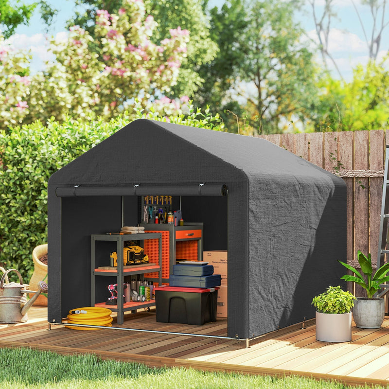 Dark grey shed on a decked patio with a workbench and storage boxes inside