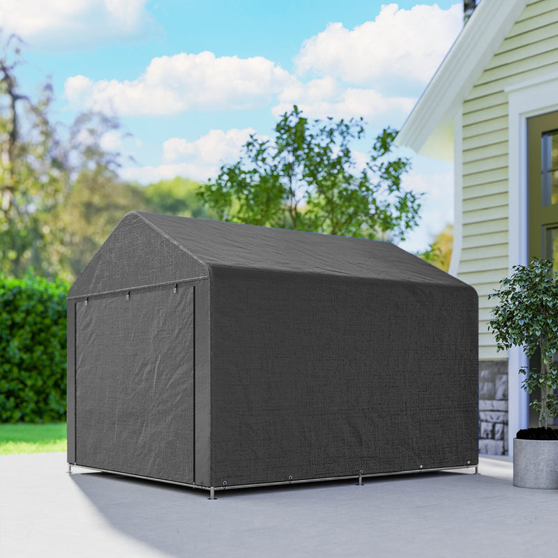 Side view of the closed dark grey shed on a paved area beside a house