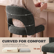 Close-up of the curved wraparound backrest and thick seat cushion on a dark grey chair