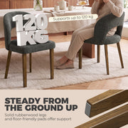 Dark grey dining chair with a 120 kg weight capacity label beside a woman seated at a table