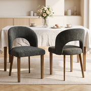 Two dark grey dining chairs at a table with flowers and tea cups