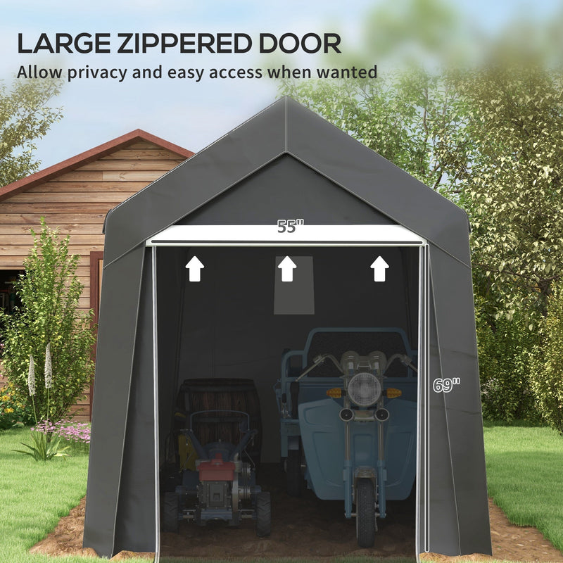 Front view of the zippered door opened wide with a scooter and mower stored inside