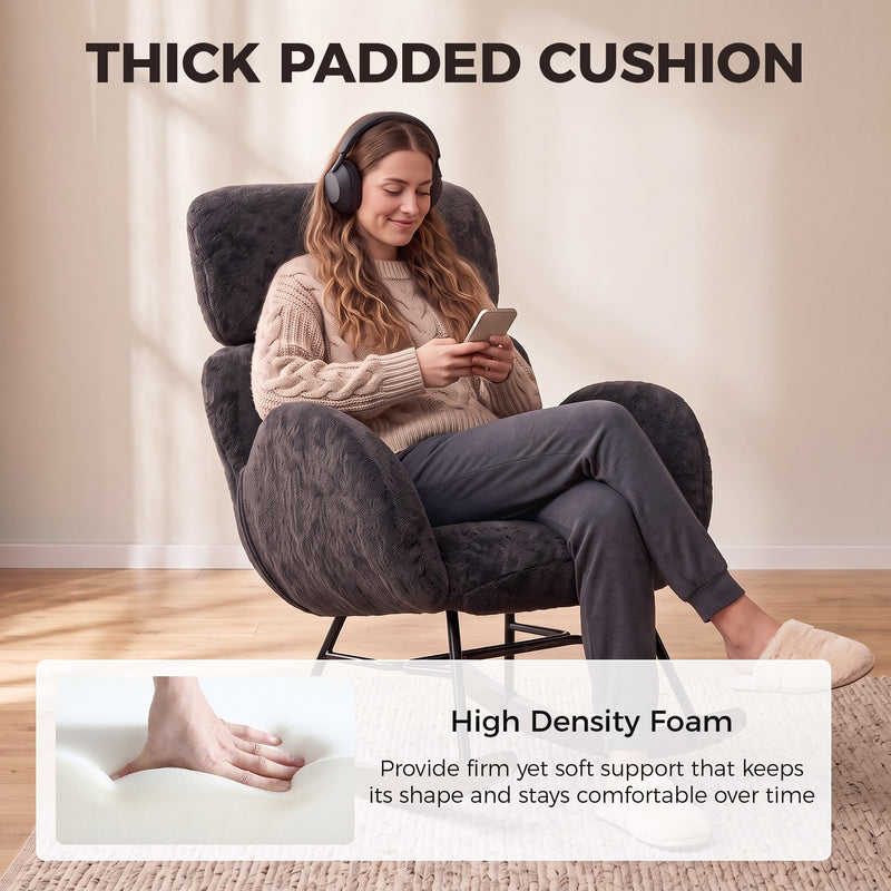 Woman relaxing on her phone in the padded dark grey rocking chair