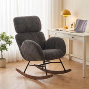 Dark grey rocking chair positioned beside a home desk and laptop