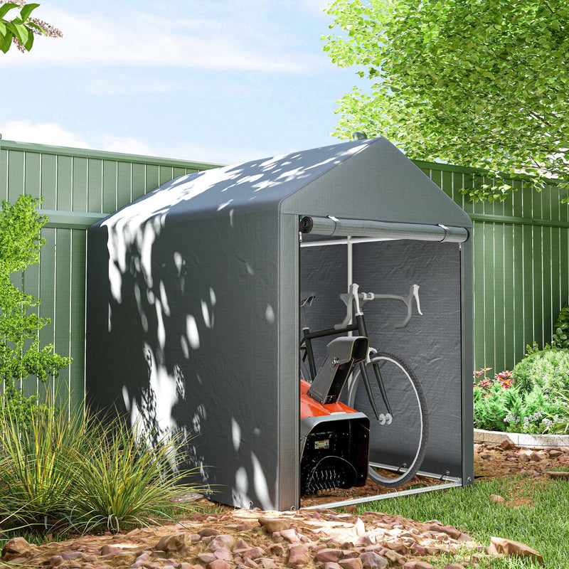 Storage shed tent standing beside a green garden fence with a bicycle parked inside