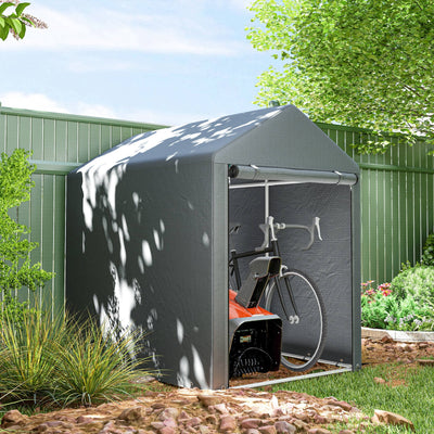 Storage shed tent standing beside a green garden fence with a bicycle parked inside
