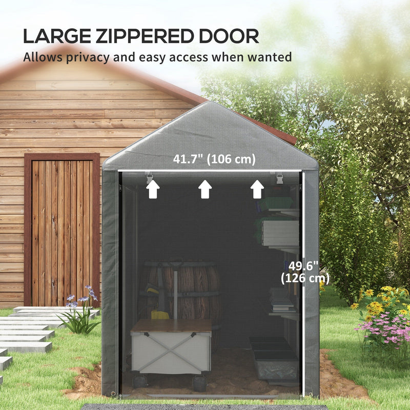 Front view of the dark grey shed tent with its door open, standing beside a wooden garden building