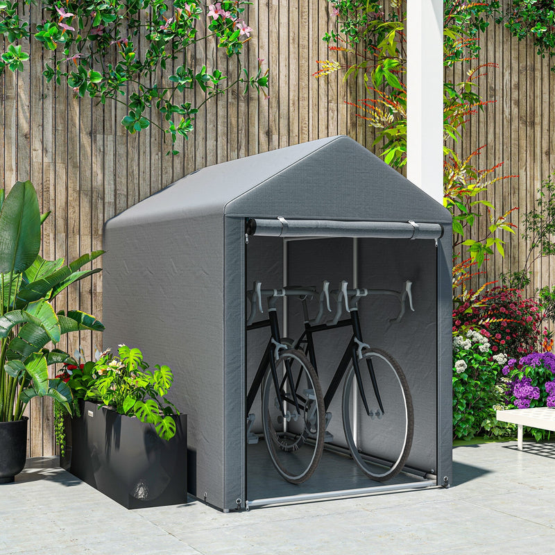 Dark grey shed tent on a patio holding two bicycles in front of a wooden fence