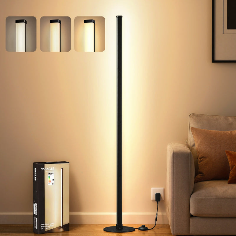 Vasagle matte black floor lamp switched on beside a beige sofa in a living room