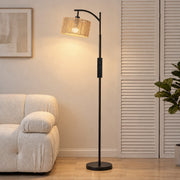 Lit floor lamp beside a cream sofa and louvred door