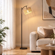 Floor lamp next to a sofa and coffee table in a bright living room