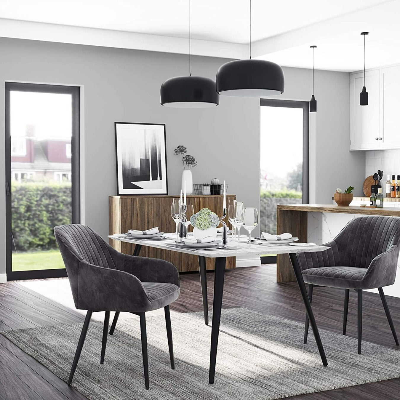 Modern dining room with gray chairs, a white table, and black pendant lights.