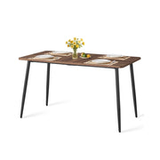 Natural Walnut and Ink Black dining table with black tapered steel legs on a plain background