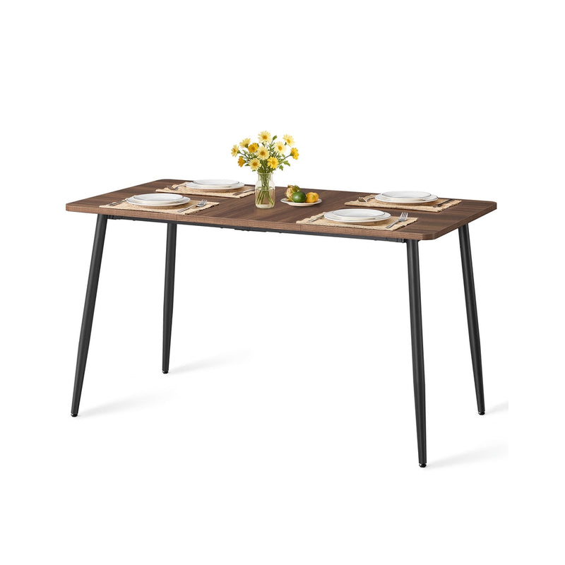 Natural Walnut and Ink Black dining table with black tapered steel legs on a plain background
