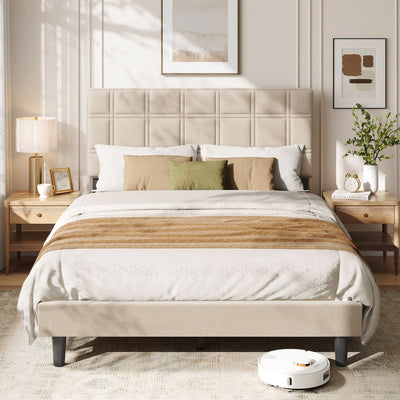 Upholstered double bed dressed with white and olive bedding between two wooden bedside tables