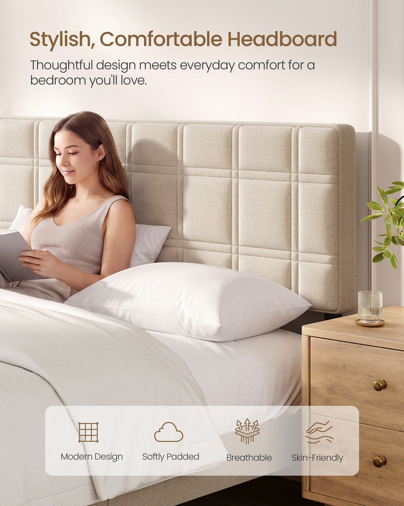 Woman reading in bed resting against the grid-stitched padded headboard