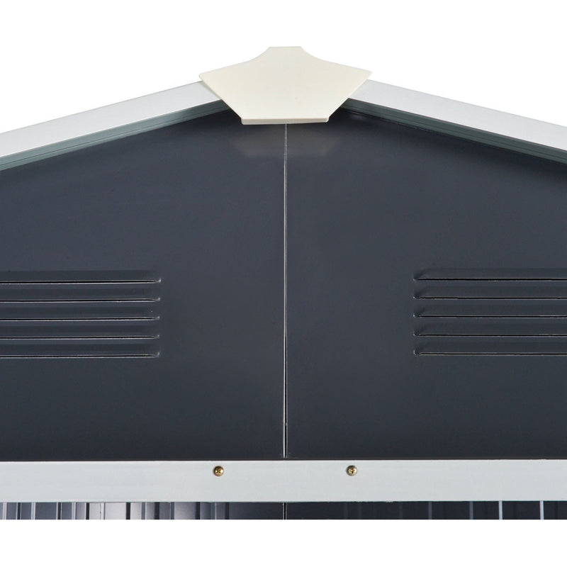 Close-up of the dark grey gable end showing the cream apex cap and two pressed louvre vents
