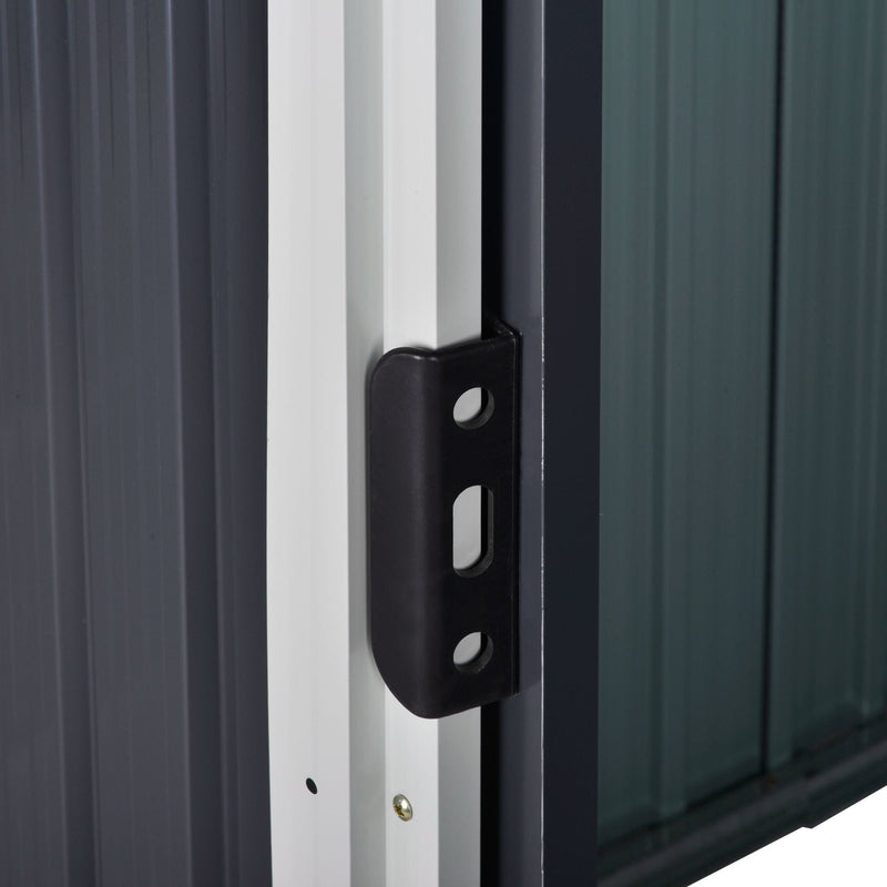 Close-up of the black sliding door handle mounted on the shed's white door frame