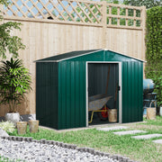 Green metal shed against a wooden fence with the doors open and a wheelbarrow parked inside