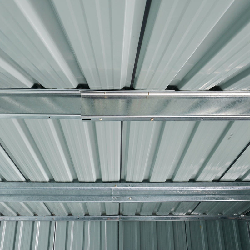 View up into the shed roof showing pale ribbed roof panels carried on galvanised steel support beams
