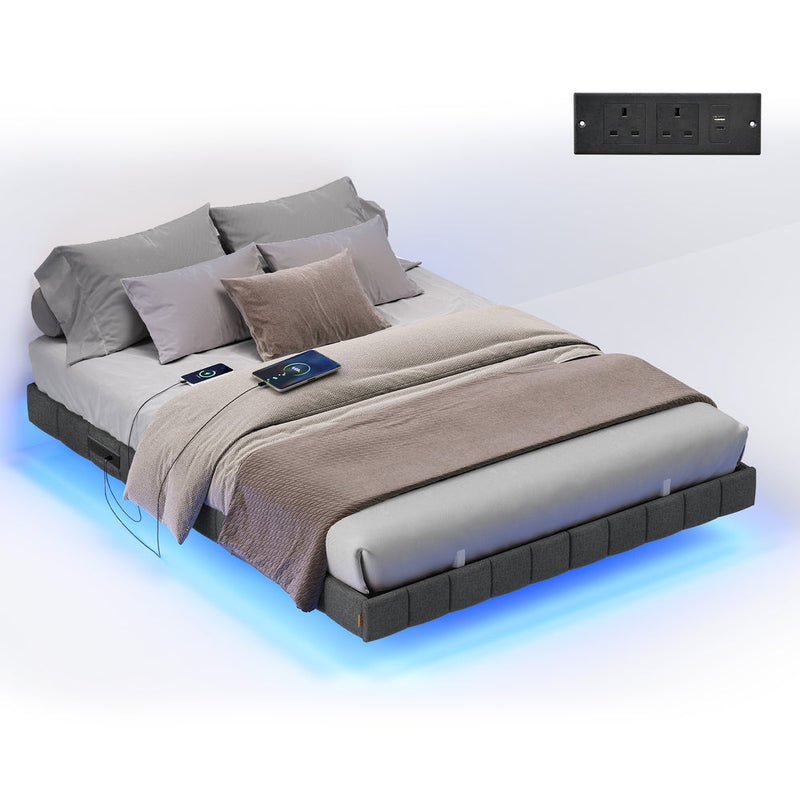 Slate grey double floating bed frame made up with bedding, with the socket panel shown inset