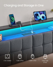 Close-up of the headboard shelf and built-in socket strip charging a phone and tablet