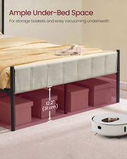 Close-up of the beige side rail with 31 cm of under-bed clearance marked above storage boxes and a robot vacuum on the carpet