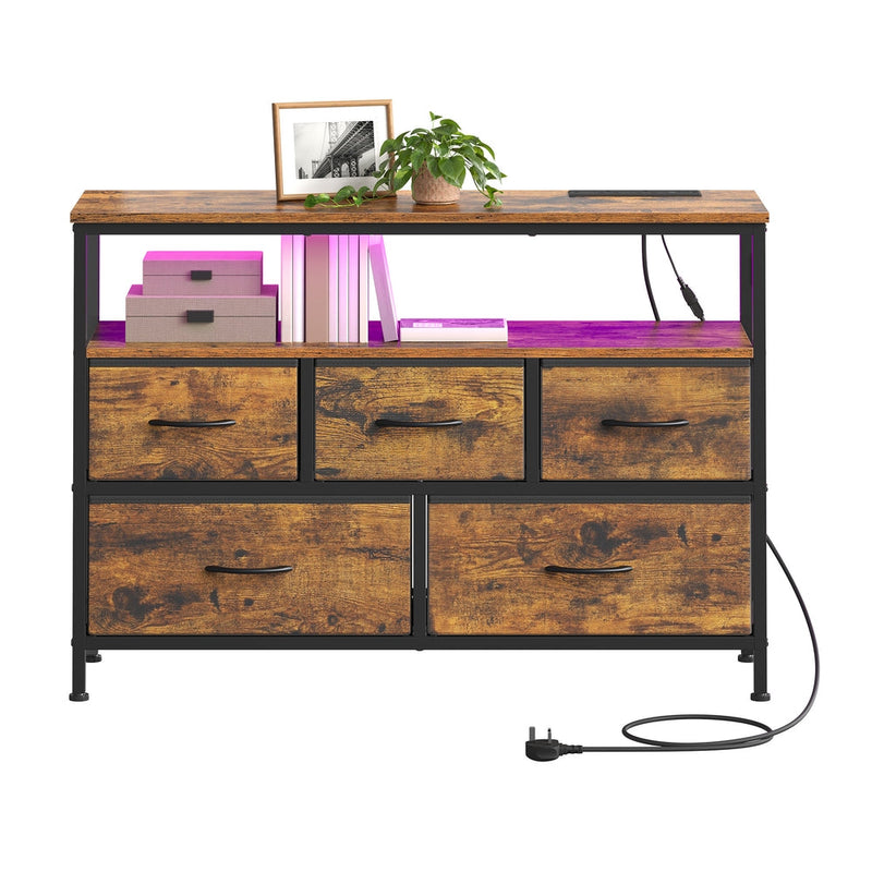 Open shelf styled with a framed photo, plant and storage boxes above the fabric drawers