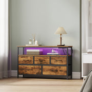 Bedroom lifestyle scene with the LED strip lit purple beside reed diffusers and a table lamp