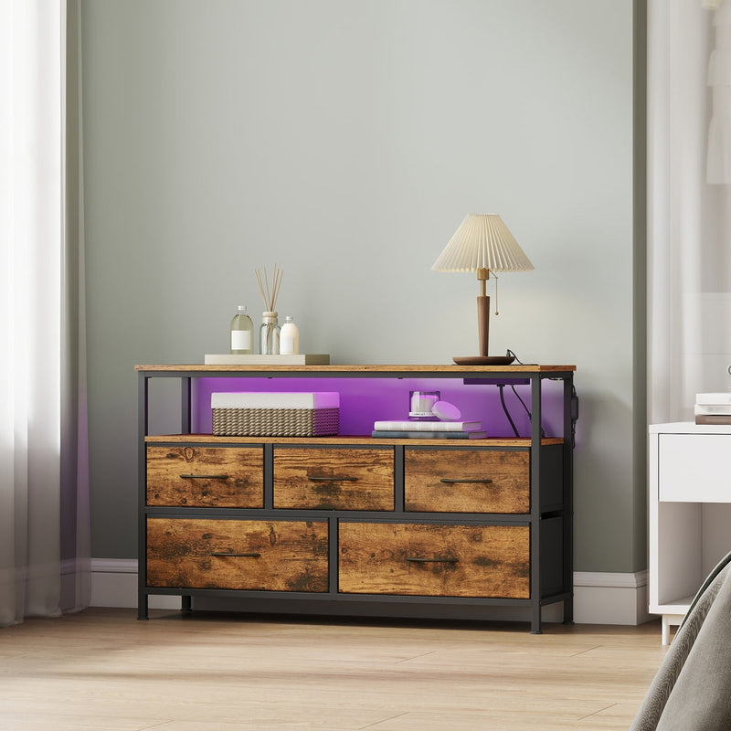 Bedroom lifestyle scene with the LED strip lit purple beside reed diffusers and a table lamp