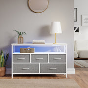Dresser in a living room with blue LED lighting under a round wall mirror
