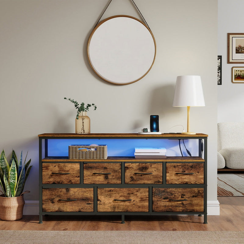 Dresser under a round wall mirror with blue LED lighting glowing on the open shelf