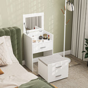 White dressing table with the mirror up and stool in a green bedroom next to a coat stand