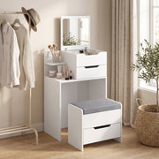 White dressing table and stool in a bedroom beside a clothes rail