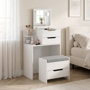 White dressing table and stool in a bedroom next to a bed