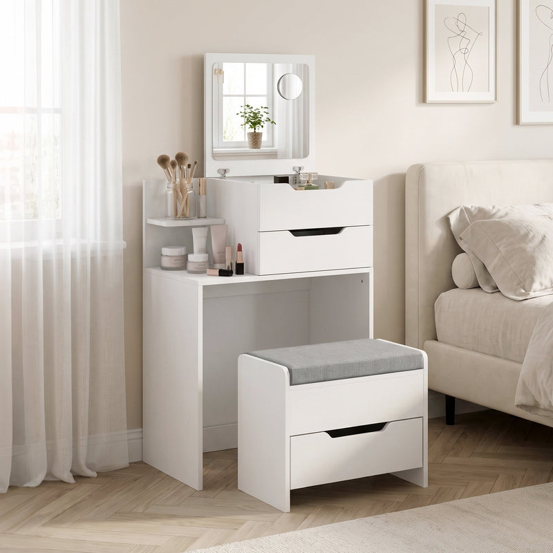 White dressing table and stool in a bedroom next to a bed