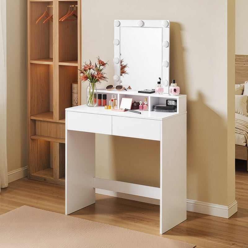 White dressing table with lighted mirror styled in a bedroom with wooden flooring