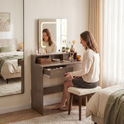 Woman sitting at the dressing table opening a drawer