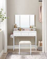 White dressing table and stool set up in a bedroom corner beside a curtain