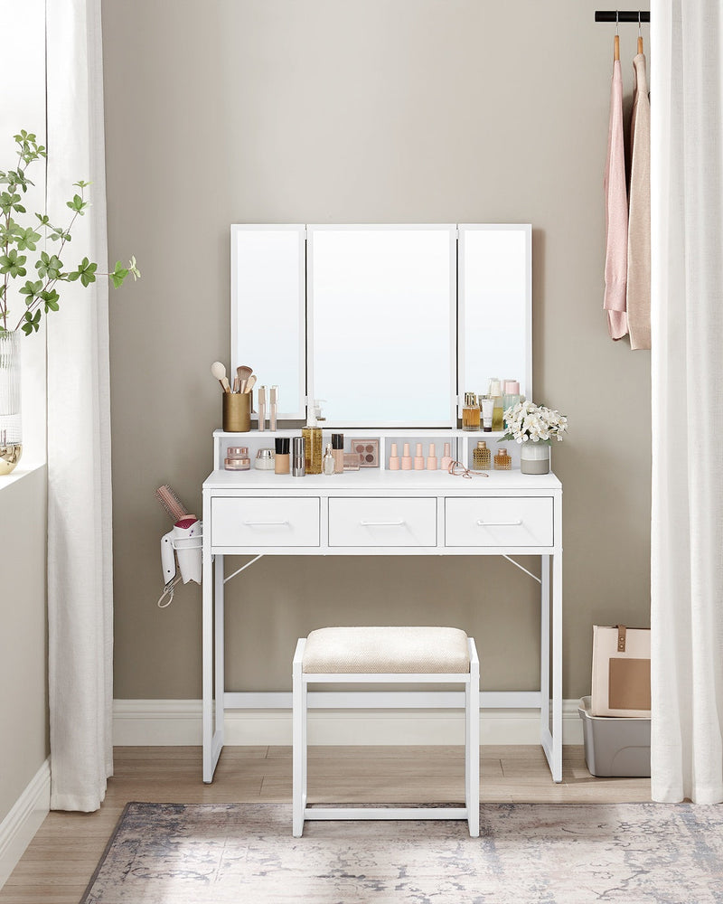 White dressing table and stool set up in a bedroom corner beside a curtain