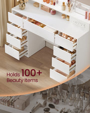 Open drawers filled with make-up and beauty products, seen from above the desk
