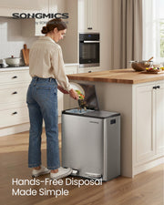 Woman disposing of food waste into the dual compartment kitchen bin in a kitchen
