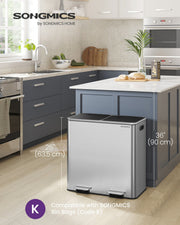 Silver dual compartment pedal bin standing 63.5 cm tall beside a kitchen island in a modern kitchen