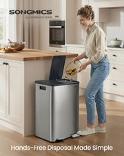 Woman scraping food scraps into the bin hands-free by stepping on the pedal in a kitchen