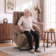 Elderly man using the electric lift function to stand from the brown recliner