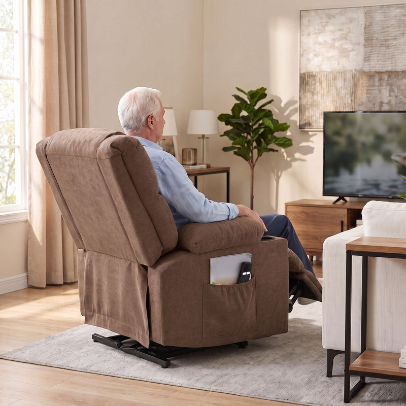 Rear view of a man reclining in the brown chair while watching television