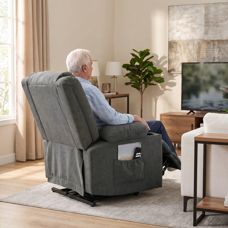 Rear view of a man reclining in the dark grey chair while watching television