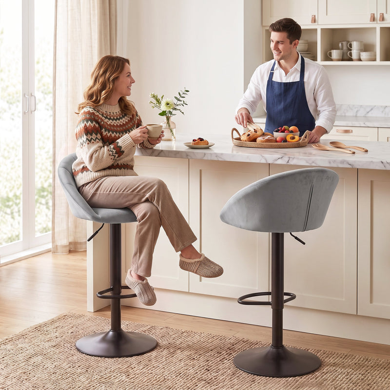 Woman sitting on a light grey Homcom bar stool at a marble kitchen island