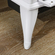 Close-up of the curved stove leg resting on a wooden floor